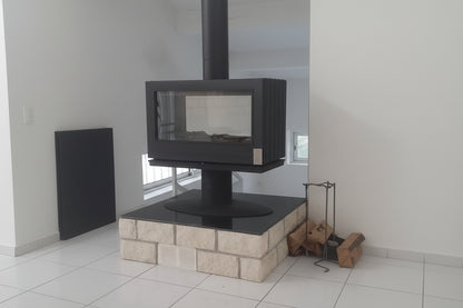 elevated Glass Fireplace with a modern French design. This see through design allows the room to stay open double glass see through fireplace JOTUL STU Don Bar Napoleon custom designed custom built big glass